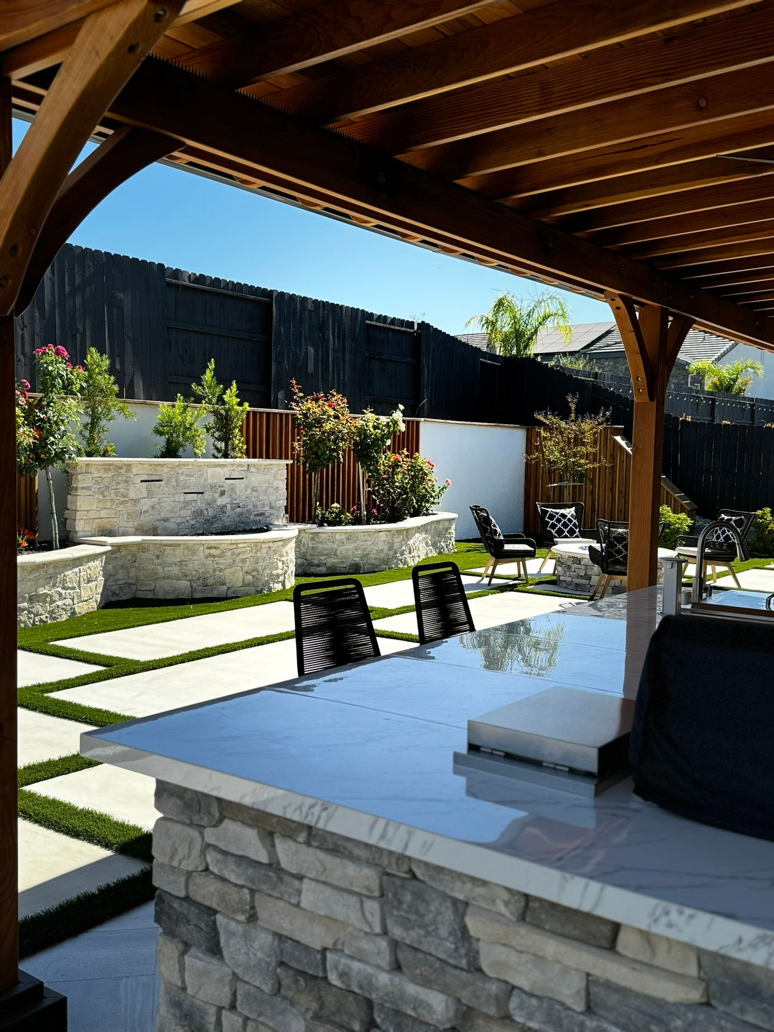 Specimen olive tree framed by modern pavers